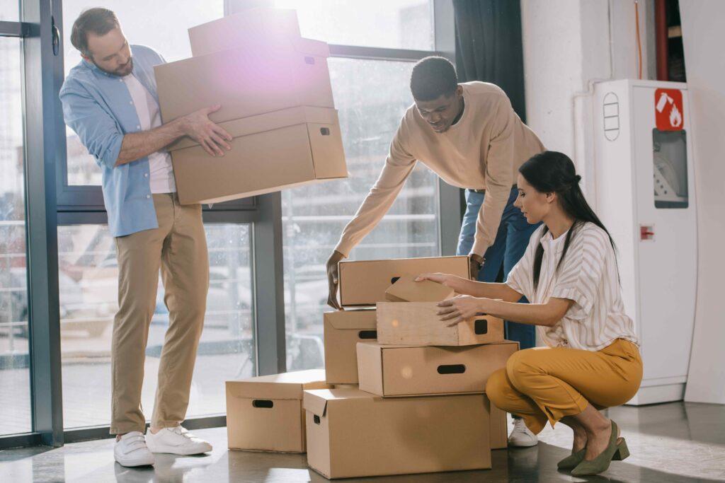 Employees handling moving boxes